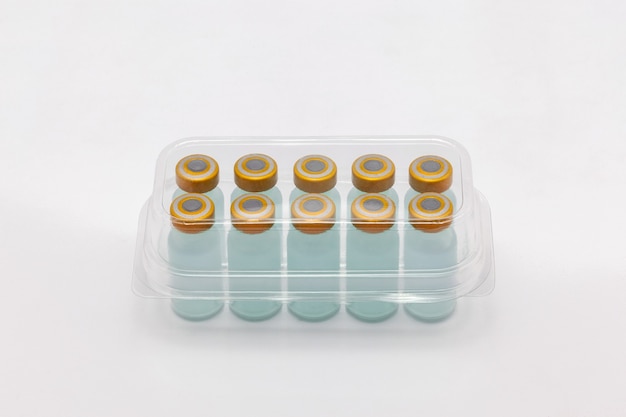 vaccine bottles inside opened translucent plastic box