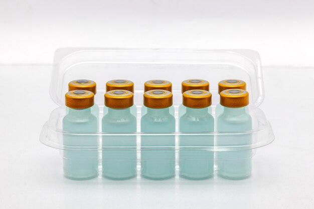 vaccine bottles inside opened translucent plastic box