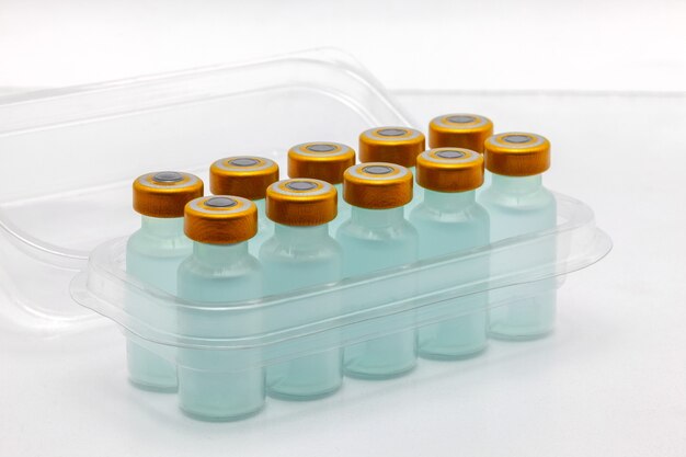 vaccine bottles inside opened translucent plastic box