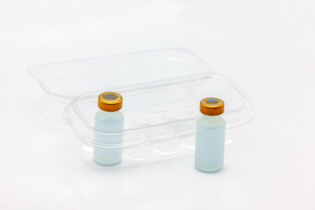 vaccine bottles inside opened translucent plastic box