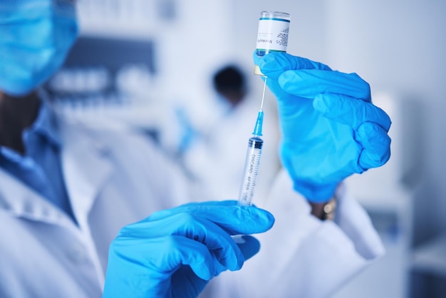 Vaccine doctor hands and monkeypox injection for safety healthcare medicine or pharmaceutical laboratory test Closeup syringe hands and liquid bottle of virus risk medical scientist and research