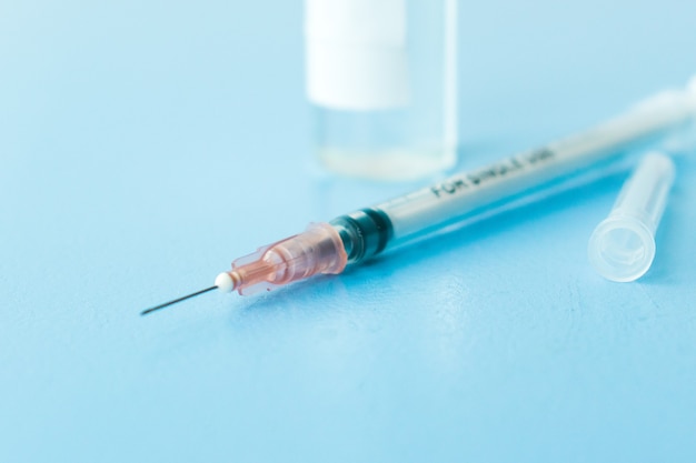 Vaccine on a vial bottle and injection Syringe on a white table