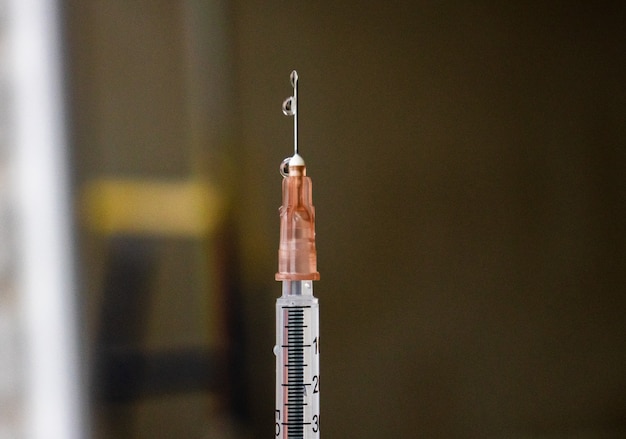 Vaccine on a vial bottle and injection Syringe on a white table