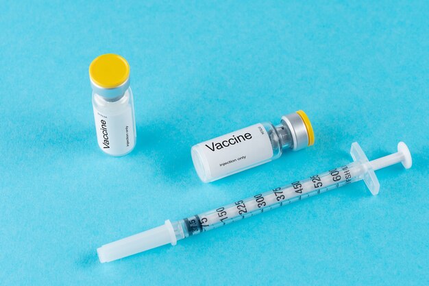 Vaccine vial glass with a syringe