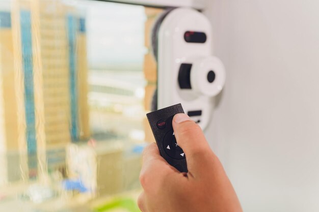 Vacuum cleaner robot cleaning window in high building outdoor