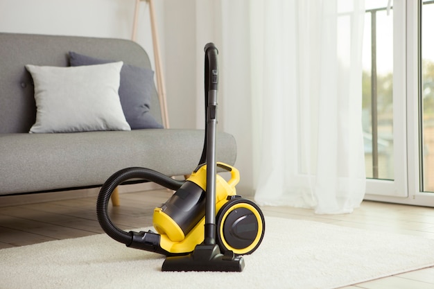 Vacuum cleaner yellow in the interior of the room