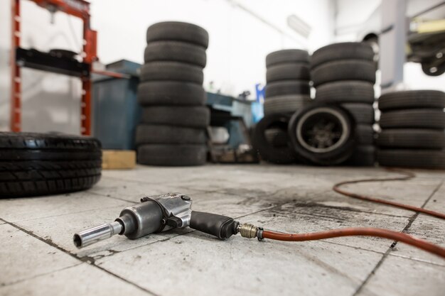 Vacuum gun for replacing wheels of the car on the floor, transportation concept