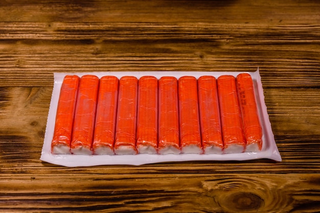 Vacuum pack of crab sticks on a wooden table