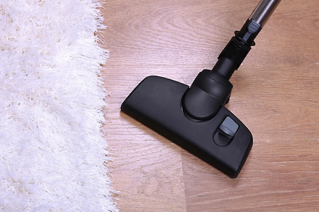 Vacuuming carpet in house