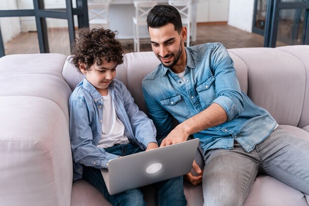 Vader en zoon brengen samen tijd thuis door. Arabische gezinslevensstijlmomenten