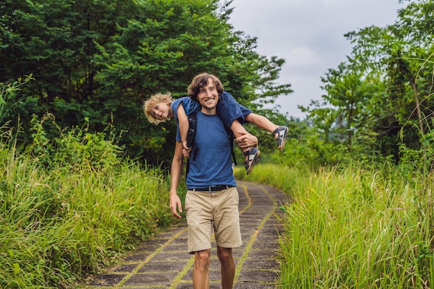 Vader en zoon toeristen in Campuhan Ridge Walk, Scenic Green Valley in Ubud Bali. Reizen met kinderen concept.