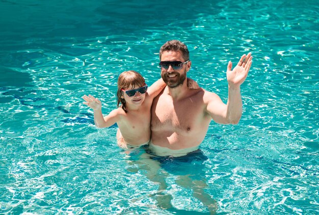 Vader en zoon zwemmen in zwembad zomer familie kind met vader spelen in zwembad aquapark fathe