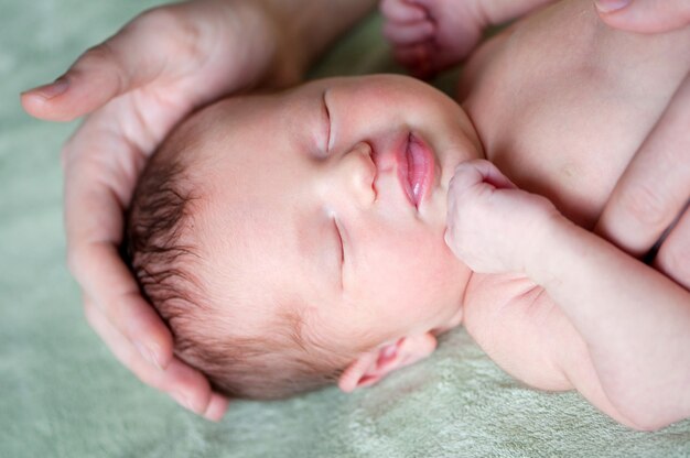 vader houdt de hand van zijn pasgeboren baby vast