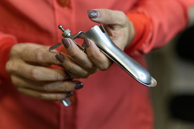 Vaginal speculum in the hand of a doctor Concept Health and Gynecology