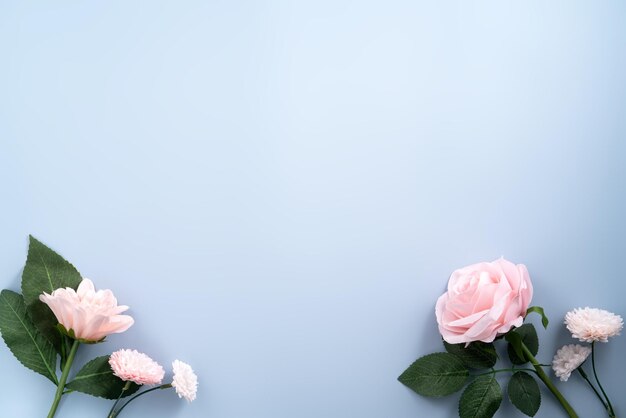 Foto valentijnsdag en moederdag cadeau winkelen ontwerp concept achtergrond met roze roos anjer bloem en verpakt cadeau doos op blauwe tafel achtergrond