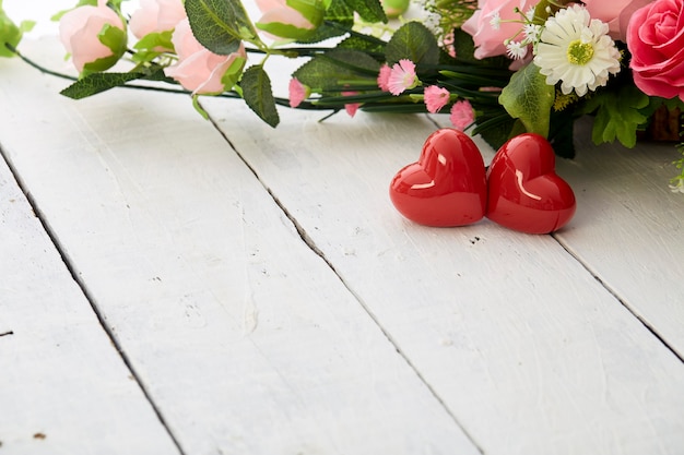 Valentin day romantic red heart and  colorful flowers bouquet on white wooden table