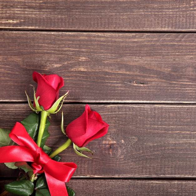 Valentine background of  red roses on wood