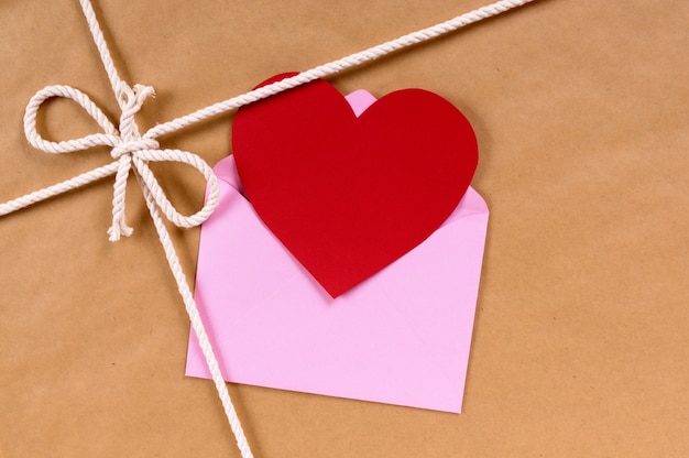 Photo valentine card on a brown paper package or gift tied with string.