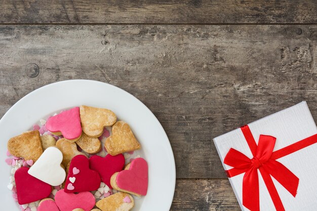 Valentine cookies with heart shape on wooden surface Top view