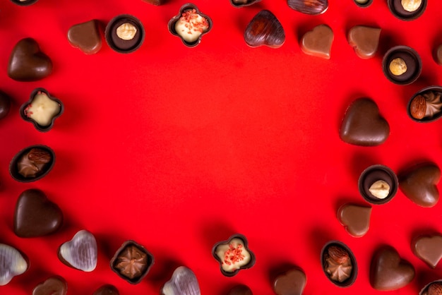 Valentine day chocolates on red background