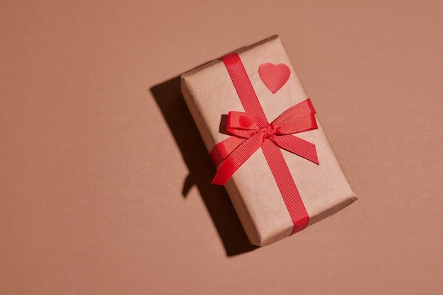 Valentine day composition with copy space.Present or gift box  with ribbon bow and red hearts.