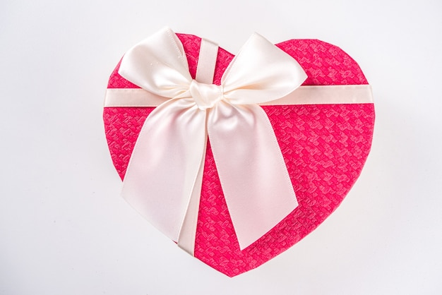 Valentine day heart shaped gift box with red ribbon bow