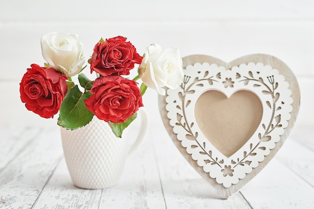 Valentine day romantic decoration with red roses flowers and frame. Happy Valentine's day greeting card.