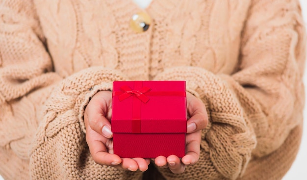 Valentine day. woman beauty hands holding small gift package\
box present wrapped paper with ribbon, christmas, new year,\
birthday holiday background concept