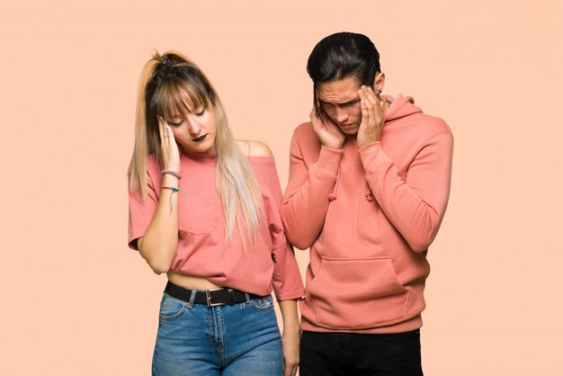 In valentine day Young couple unhappy and frustrated with something over pink background