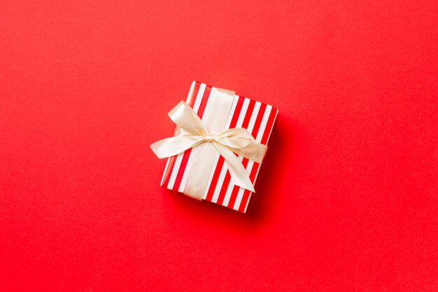 Valentine gift box on colored background, top view