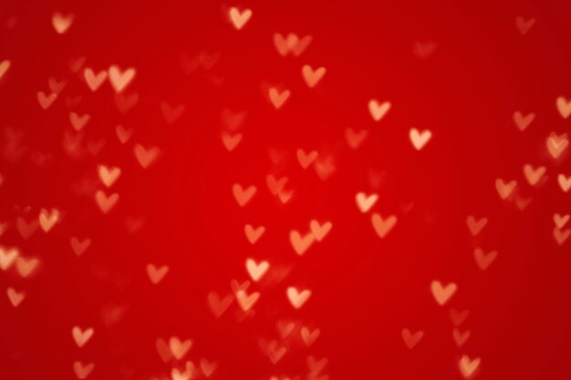 Valentine heart bokeh lights against a red background