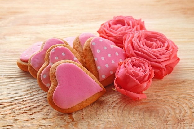 Valentine heart cookies with roses on wooden background