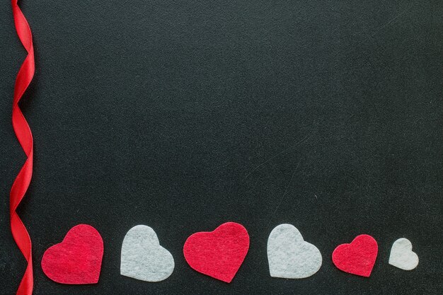 Valentine hearts on black chalkboard