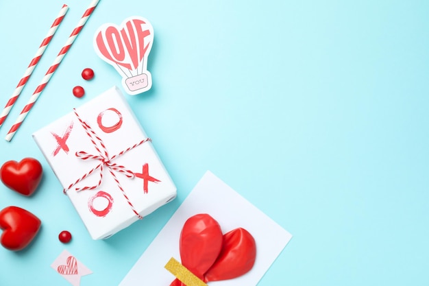 Valentine's Day accessories on blue background, space for text