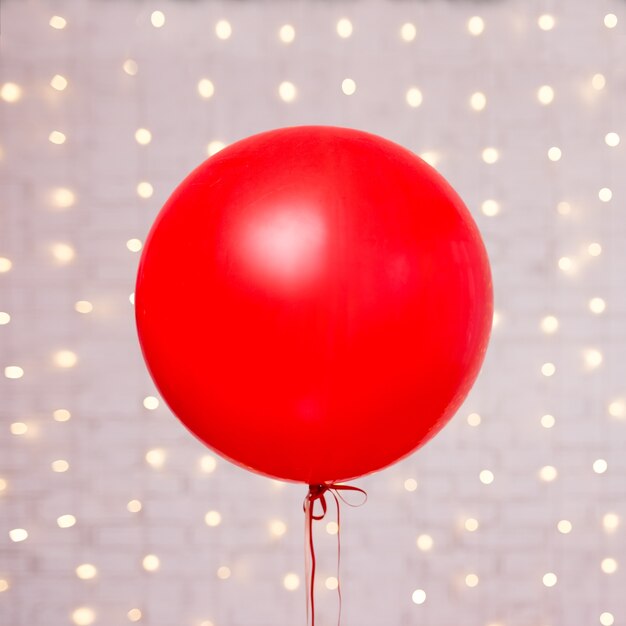 Valentine's day background - big red balloon over white brick wall