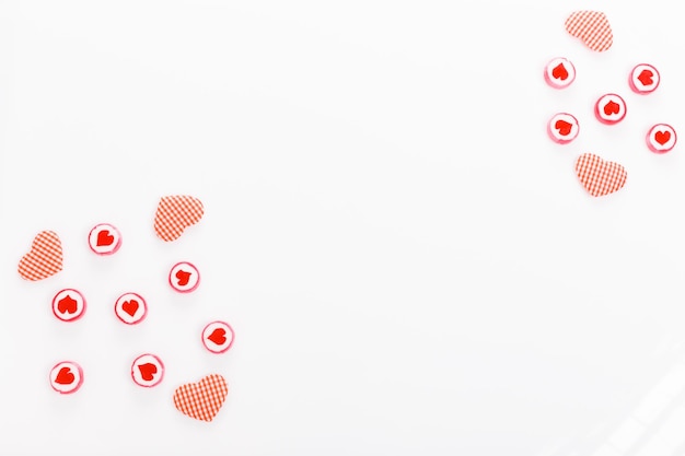 Valentine's Day background. Sweet candy lollipops with hearts,white and red hearts on white background. Birthday, Mother's, Women's, Wedding Day concept. Flat lay, top view, copy space