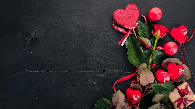 Valentine's Day Banner. Roses and a gift. On a wooden background. Top view. Free space for your text.