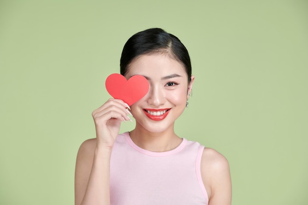 Valentine's Day Beautiful young woman with heart in her hands