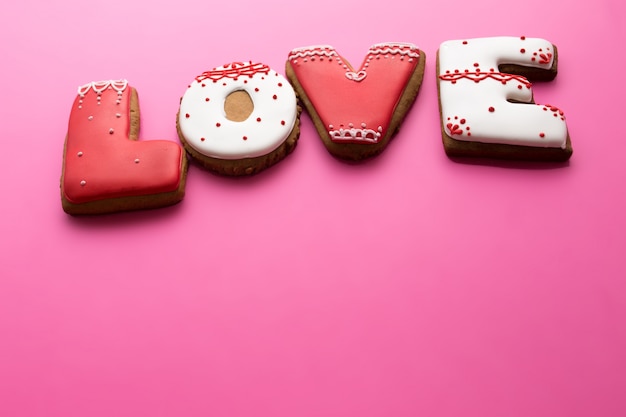 Valentine's Day. Biscuits with love on a pink background.