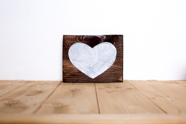 Valentine's Day on a board painted white heart background