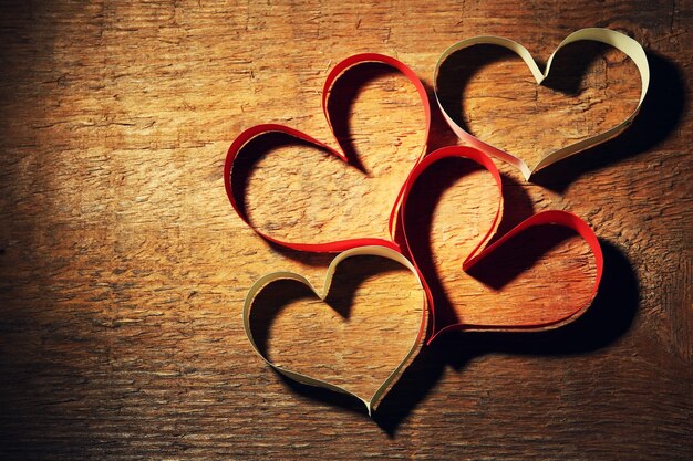 Valentine's Day card made of ribbon on wooden background