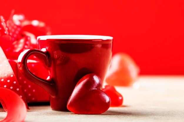 Valentine's day celebration or love concept Cups of tea or coffee with heart shape red background Copy space