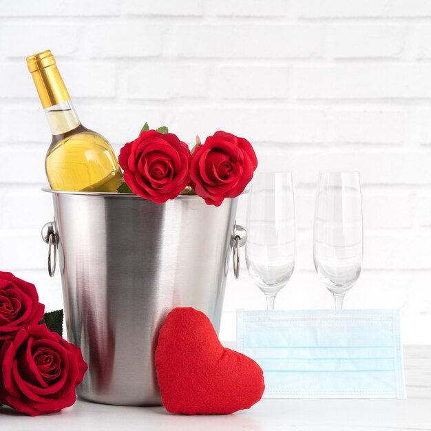 Valentine's Day celebration with wine, bouquet and face mask protection concept during this hard time.