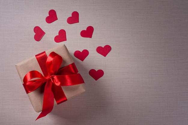 Valentine's day composition with gift and red hearts. Copy space