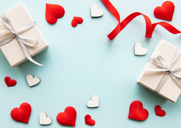 Valentine's Day composition with hearts, present boxes and red ribbon