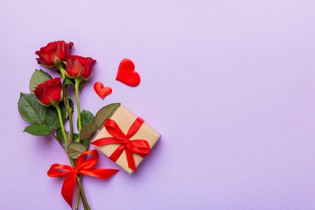 Valentine\'s day composition with rose flower red heart and gift\
boxes on table mother day and birthday greeting copy space top\
view