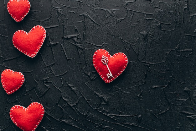 Valentine's Day Concept. Decorative hearts with keys on a black background.