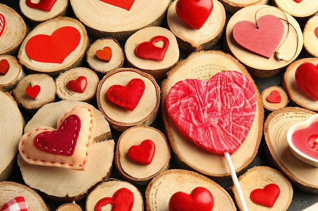 Photo valentine's day concept different colourful hearts on wooden stumps background