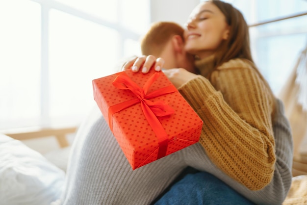 Valentine's Day concept Exchange of gifts Young couple at home celebrating Valentine's Day