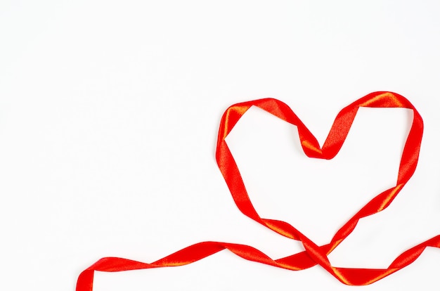 Valentine's day concept. Heart made of bright red ribbon